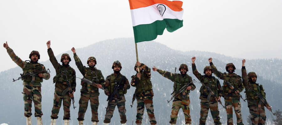 Jammu and Kashmir, Jan 26 (ANI): Army Jawans hold the National Flag and raise slogans near the snow-covered border on the occasion of 71st Republic Day in Kupwara on Sunday. (ANI Photo)